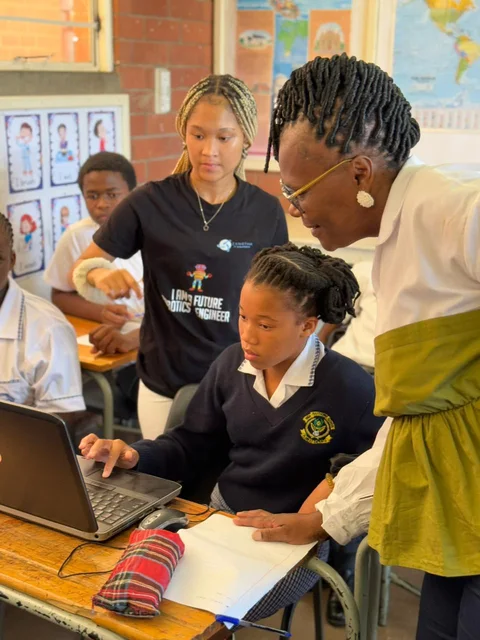 A learner receiving guidance at a laptop